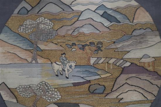 A Chinese kesi woven roundel, in gilt and polychrome thread of a figure in a mountainous landscape on horseback 24 x 26cm